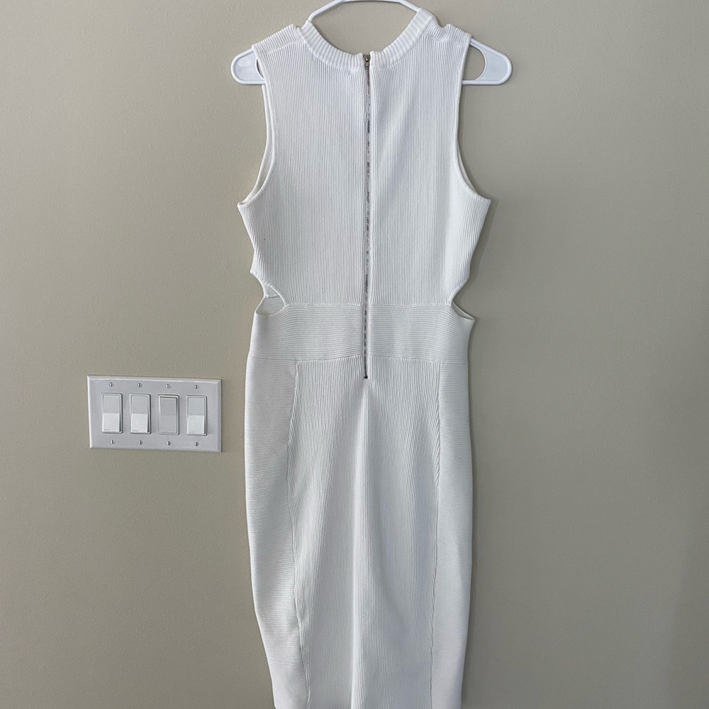 White dress with cut outs on the side. Cut outs are not to drastic.